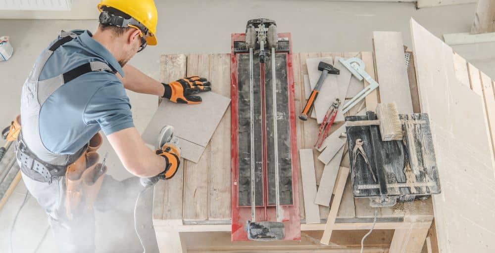 A tradie using an working with his tools on the table.